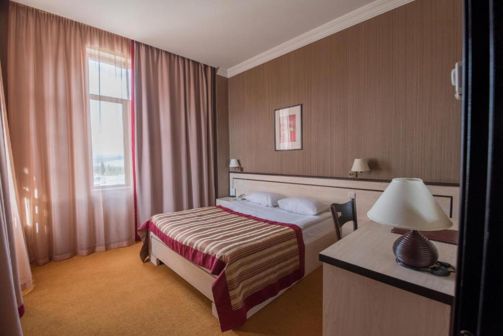 Postel nebo postele na pokoji v ubytování Hotel Rike park