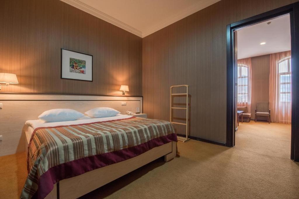 Postel nebo postele na pokoji v ubytování Hotel Rike park