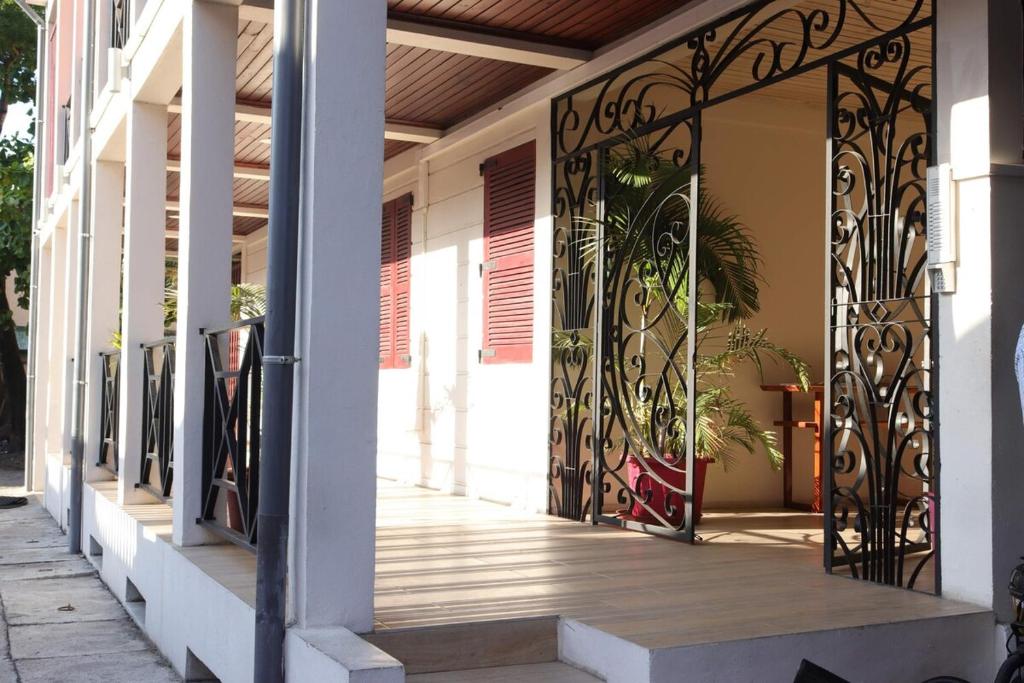 a porch with a iron gate on a building at La Créole APT10 in Toamasina