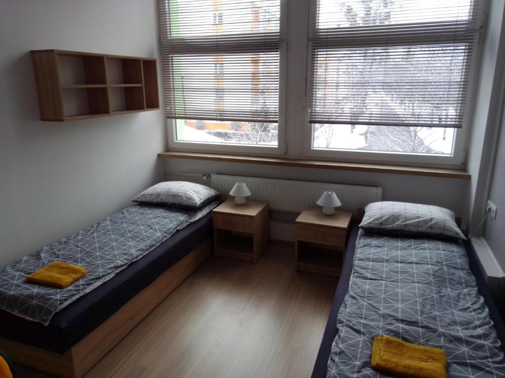 CisowaにあるHostel przy Gniewskiejの窓が2つある部屋にベッドが2つある