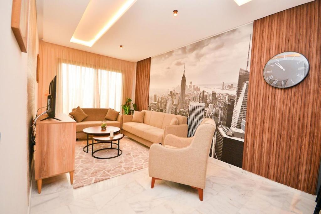 a living room with a couch and a clock on a wall at Atelier Aedes - Studio 15 in Maarif