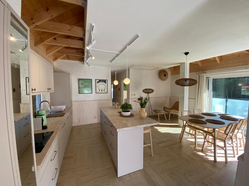 a kitchen and dining room with a table and chairs at Choriatiki in Dębki