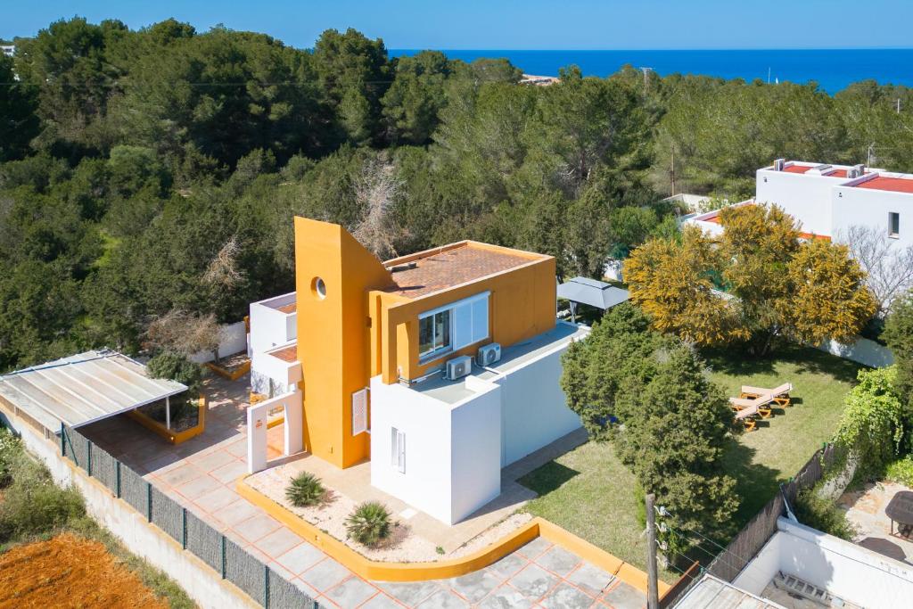an aerial view of a yellow and white house at Villa paz in Sant Josep de Sa Talaia