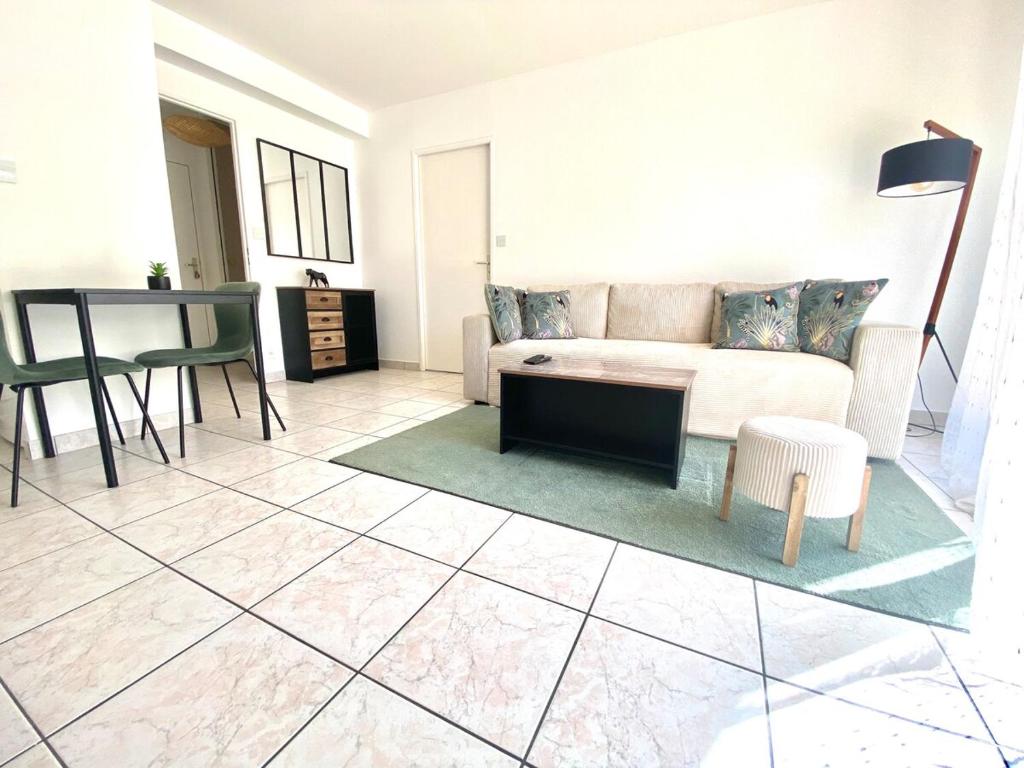 un salon avec un canapé et une table dans l'établissement Toison avec piscine, à Dijon