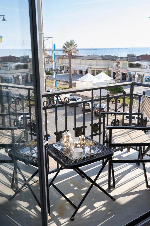 a table with a tray of food on a balcony at Palace Hotel in Viareggio