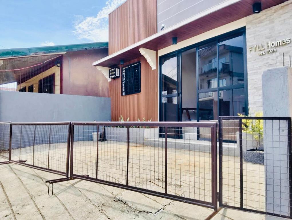 a metal fence in front of a building at FYLL Homes Ysabella Suite Calvario St Cavinti Town Proper in Cavinti