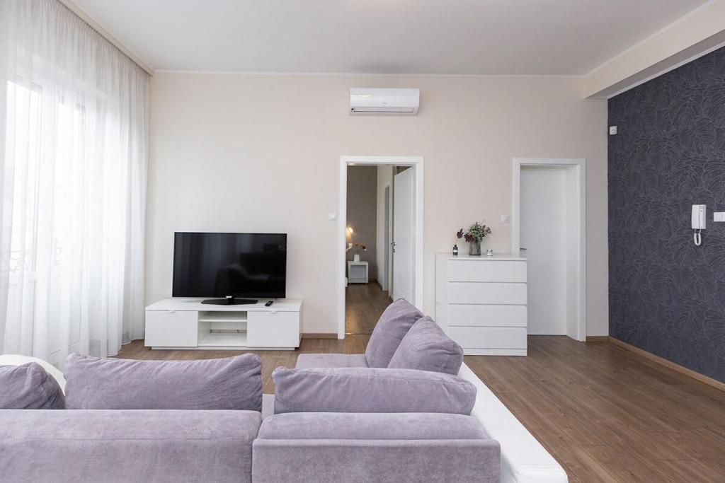 a living room with a couch and a tv at Top City Center Apartment! in Budapest