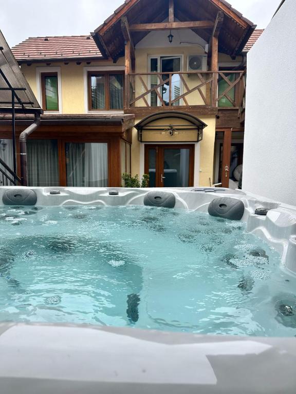 a large pool of water in front of a house at Real home 1 in Sibiu