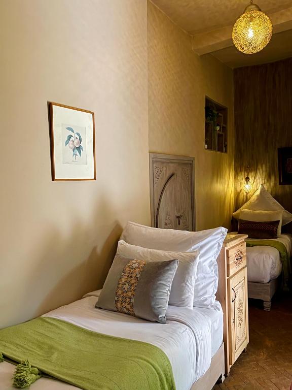 Postel nebo postele na pokoji v ubytování Riad La Calèche & SPA