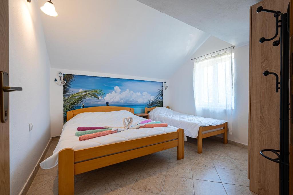 a bedroom with a bed with a painting on the wall at Apartments Ivo Bozinovic in Tivat