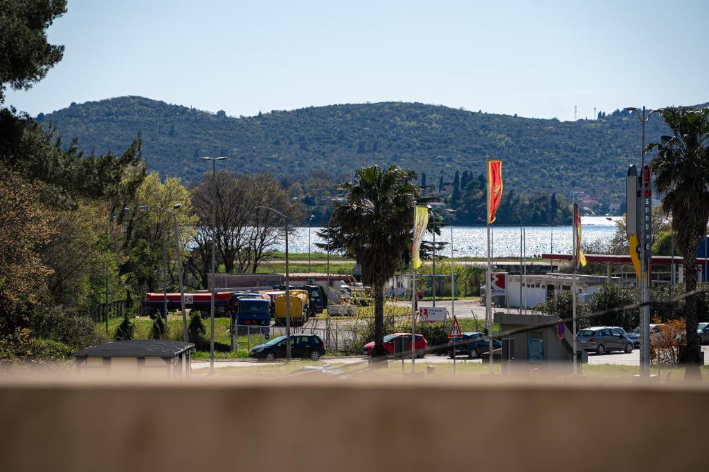 a parking lot with cars parked in a parking lot at Apartments Ivo Bozinovic in Tivat