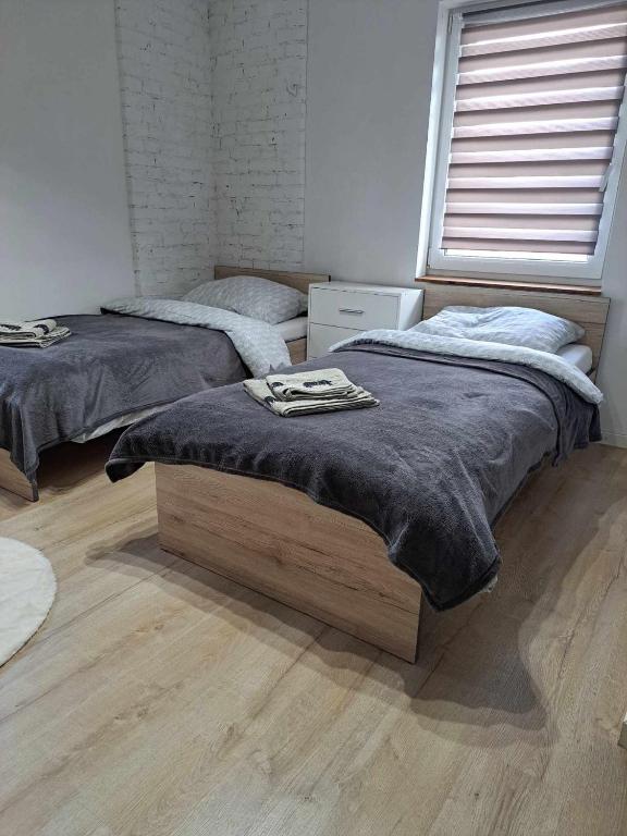 Łóżko lub łóżka w pokoju w obiekcie Stary Młyn