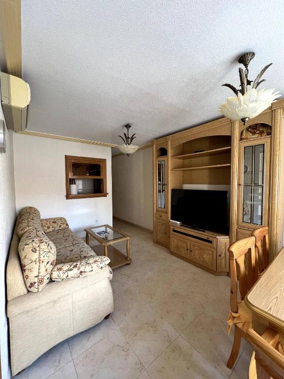 a living room with a couch and a television at Apartment in Strandnähe in Guardamar del Segura