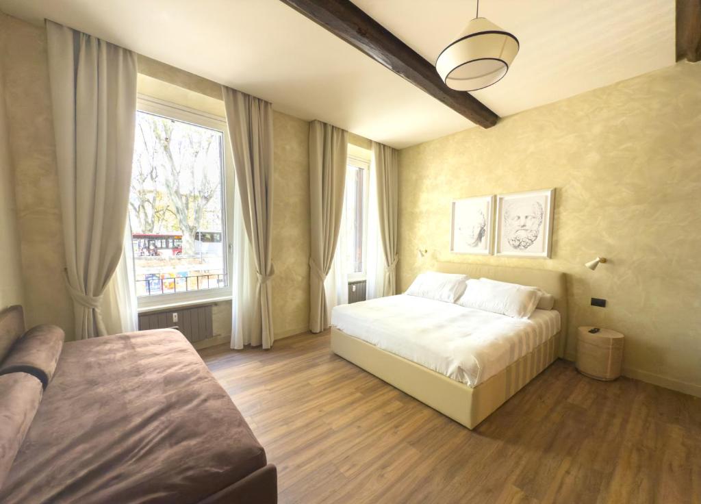 a bedroom with a bed and a large window at Pantheon Urbes Collection in Rome