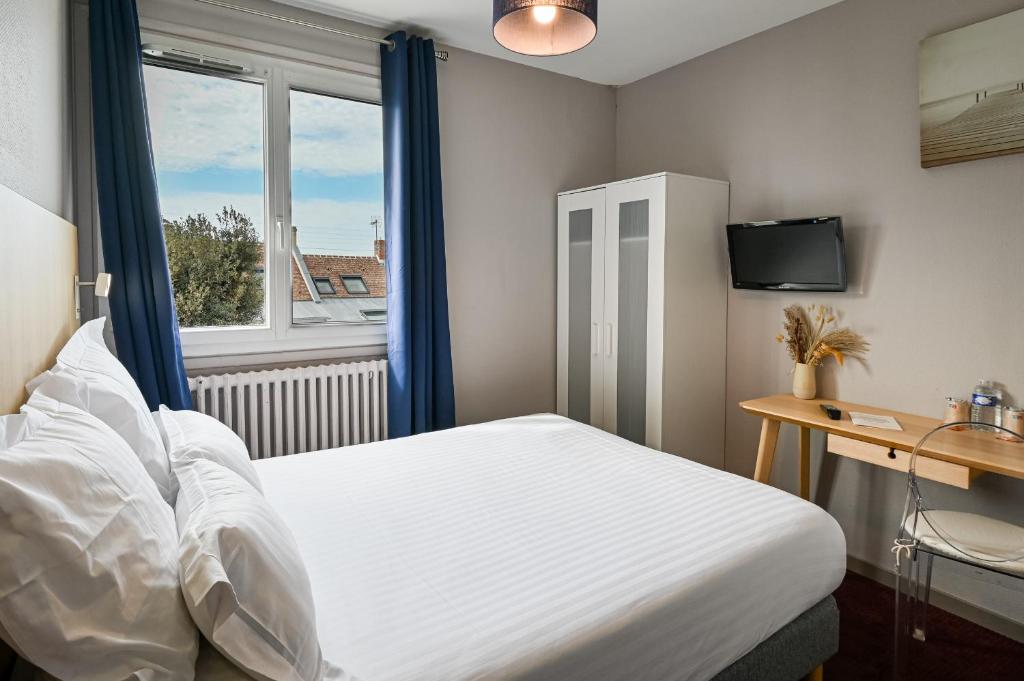 a bedroom with a white bed and a window at Saint Aubin Logis Hôtel & Restaurant in Saint-Aubin-sur-Mer
