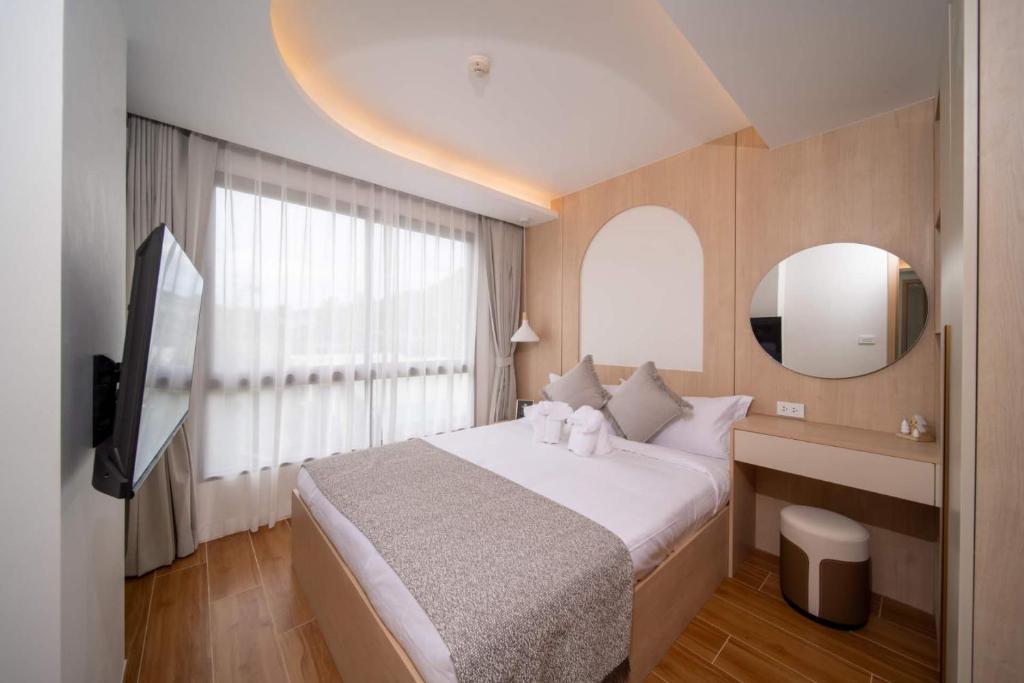 a bedroom with a large bed and a mirror at now condo near beach 2bedroom in Kamala Beach