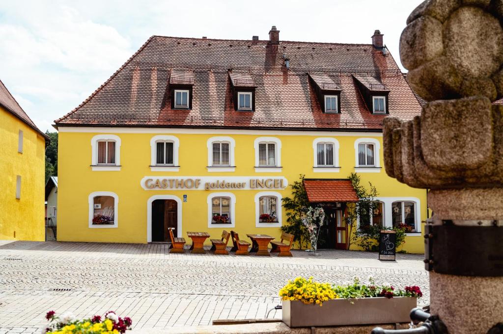 a yellow building in the center of a town at Gasthof goldener Engel in Kemnath