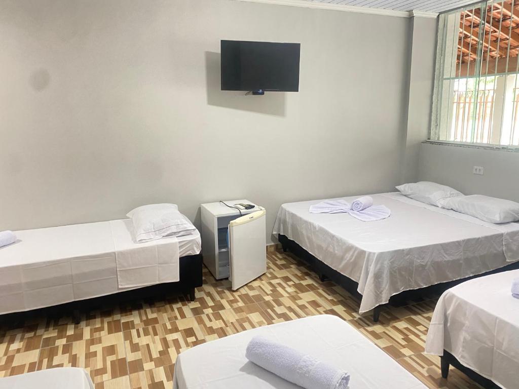 Postel nebo postele na pokoji v ubytování Pousada Sagrada Devoção
