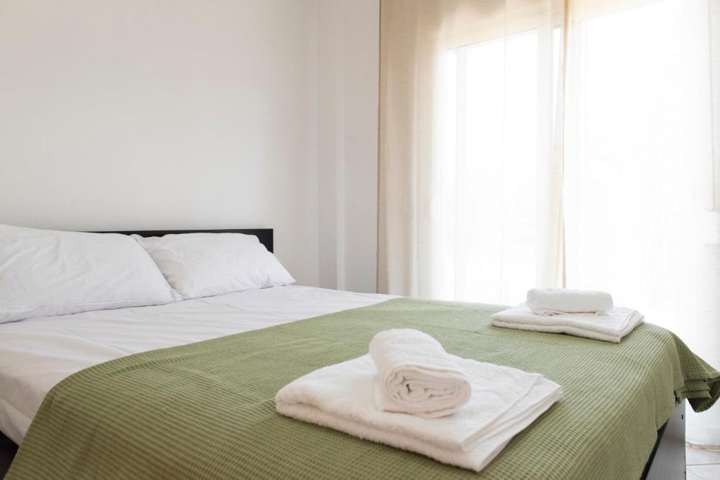 a bedroom with two towels on a bed at Annas Apartment Kalithea in Kallithea Halkidikis