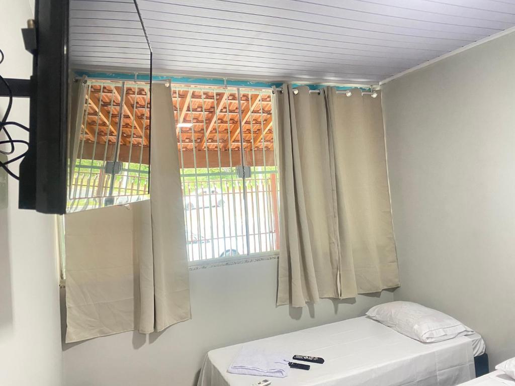 Postel nebo postele na pokoji v ubytování Pousada Sagrada Devoção