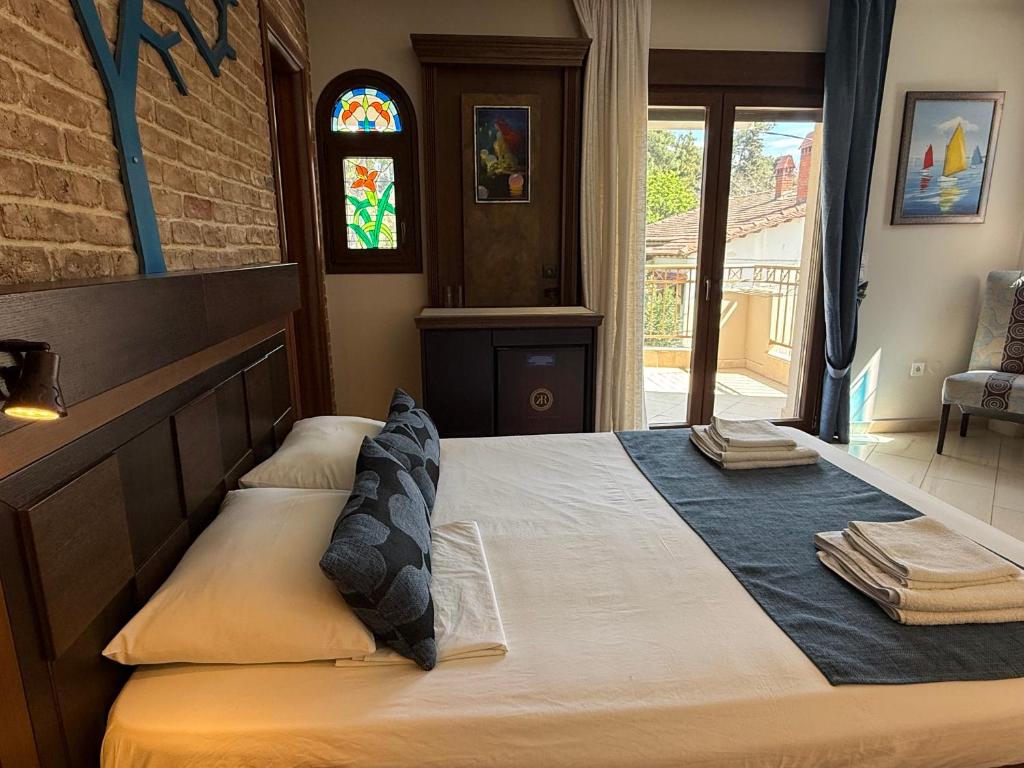 Postel nebo postele na pokoji v ubytování Kappa Rooms Boutique Hotel