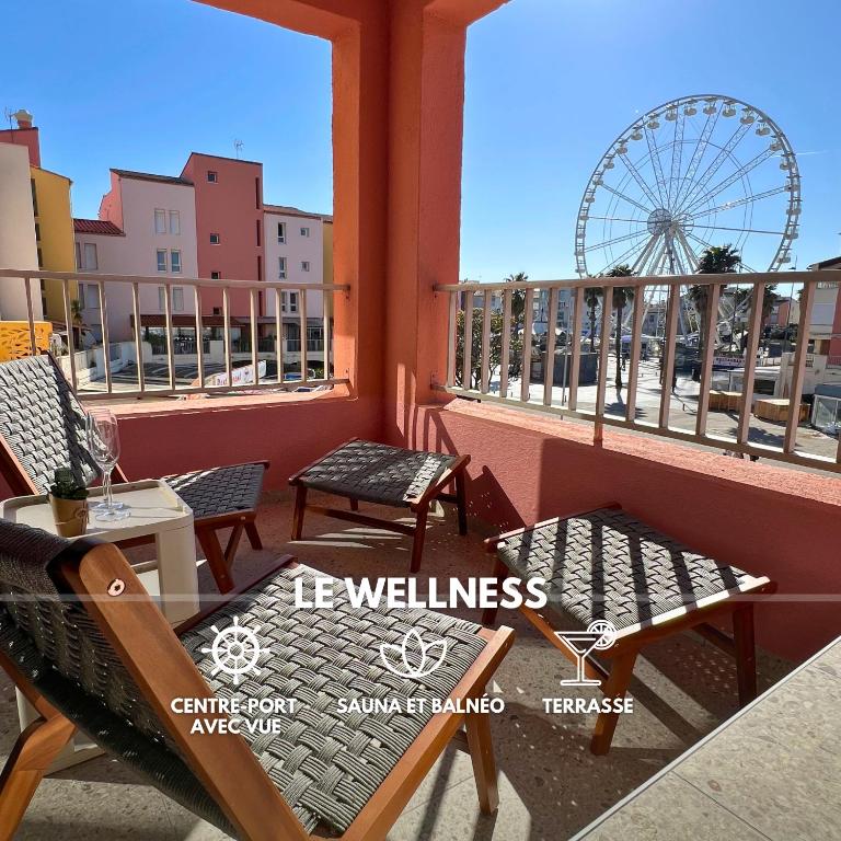 un balcon avec des chaises et une grande roue en arrière-plan dans l'établissement Évasion de luxe avec spa privé, Centre-Port Le Cap, au Cap d'Agde