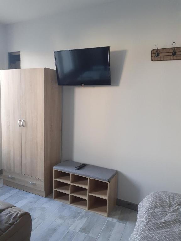 Cette chambre dispose d'une télévision murale. dans l'établissement GITE Le Petit Doué, à Saint-Malo-du-Bois