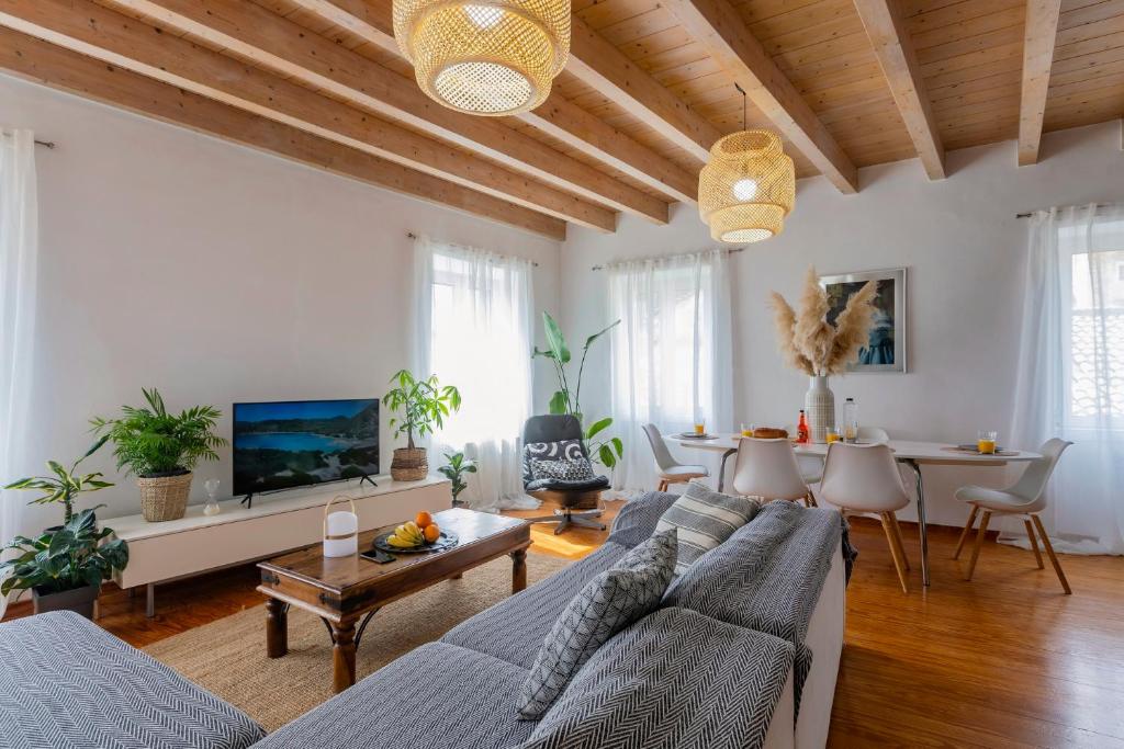 a living room with a couch and a table at Artist Loft in Corfu