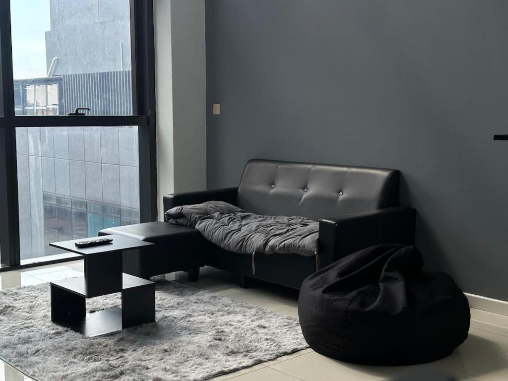a living room with a couch and a table at 3volution Stays in Petaling Jaya
