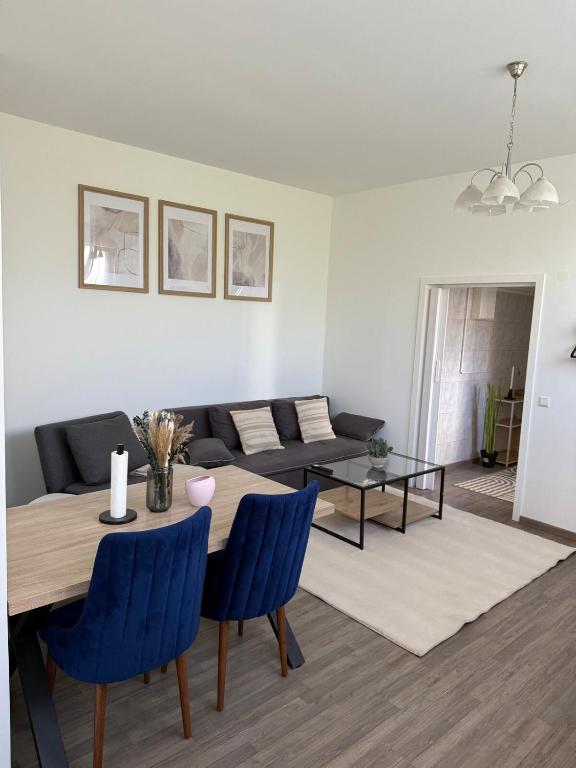 a living room with a table and a couch at Modern Living - Im Grund in Spaichingen