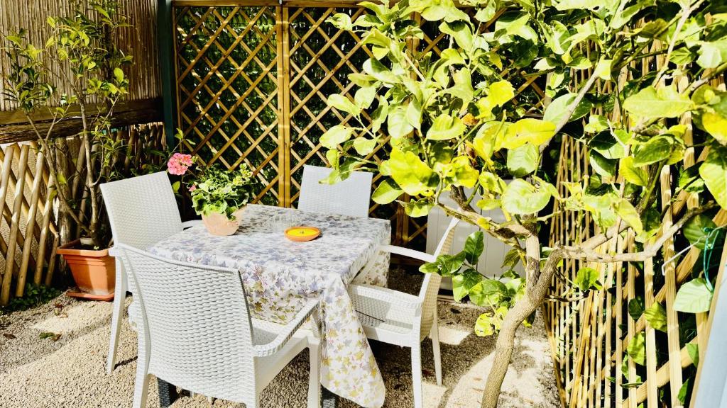 a table and chairs on a patio next to a tree at The Dream in Massa Lubrense
