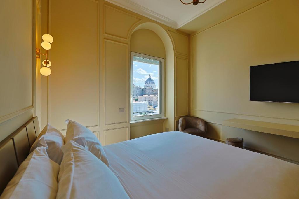 a bedroom with a large bed and a window at Residenza Alferini - San Pietro in Rome
