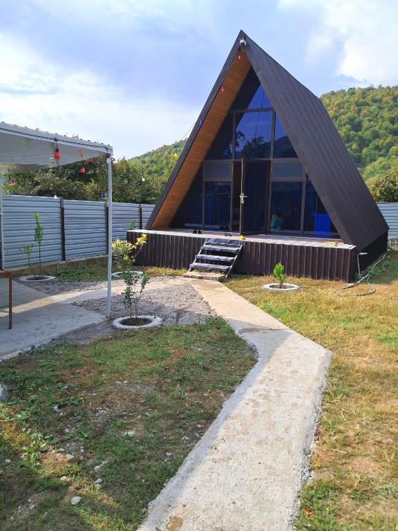 a small house with a gambrel roof at Xalxal Luxe Lodge in Oğuz