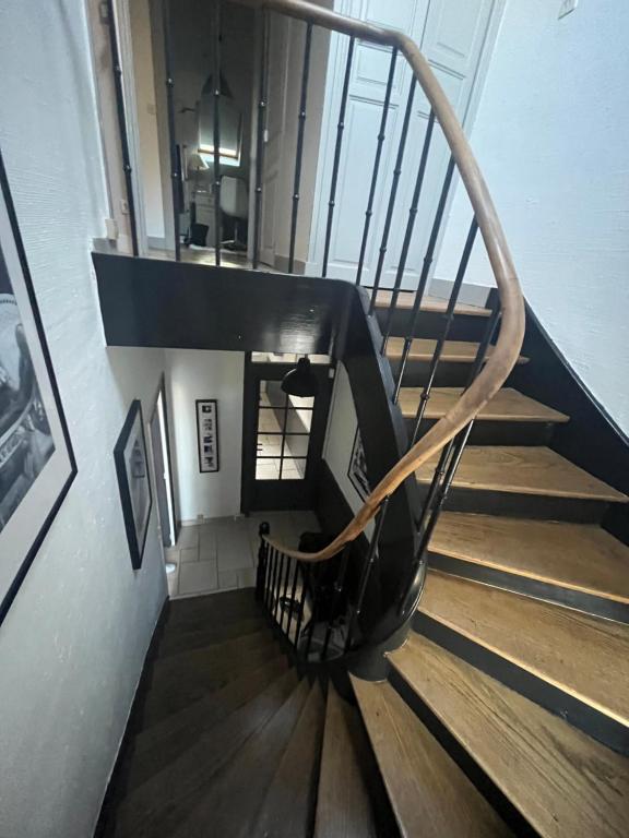 a spiral staircase in a building with wooden floors at Maison 5mn du centre ville du Mans à pied in Le Mans