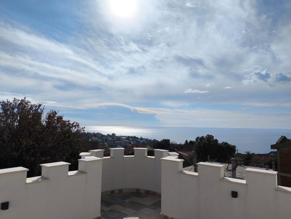 a white fence with a view of the ocean at Green Castle in Kunje