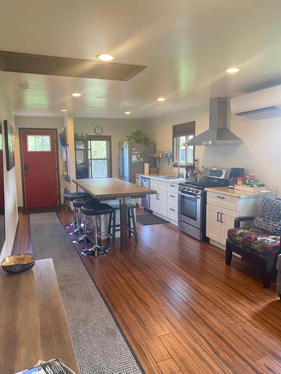a kitchen with a wooden floor and a table with chairs at Muttley's Cottage in Independence