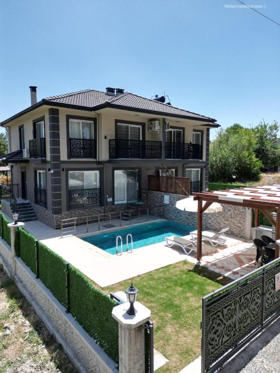 a house with a swimming pool in the yard at Villa BB Mugla 1 in Ortaca