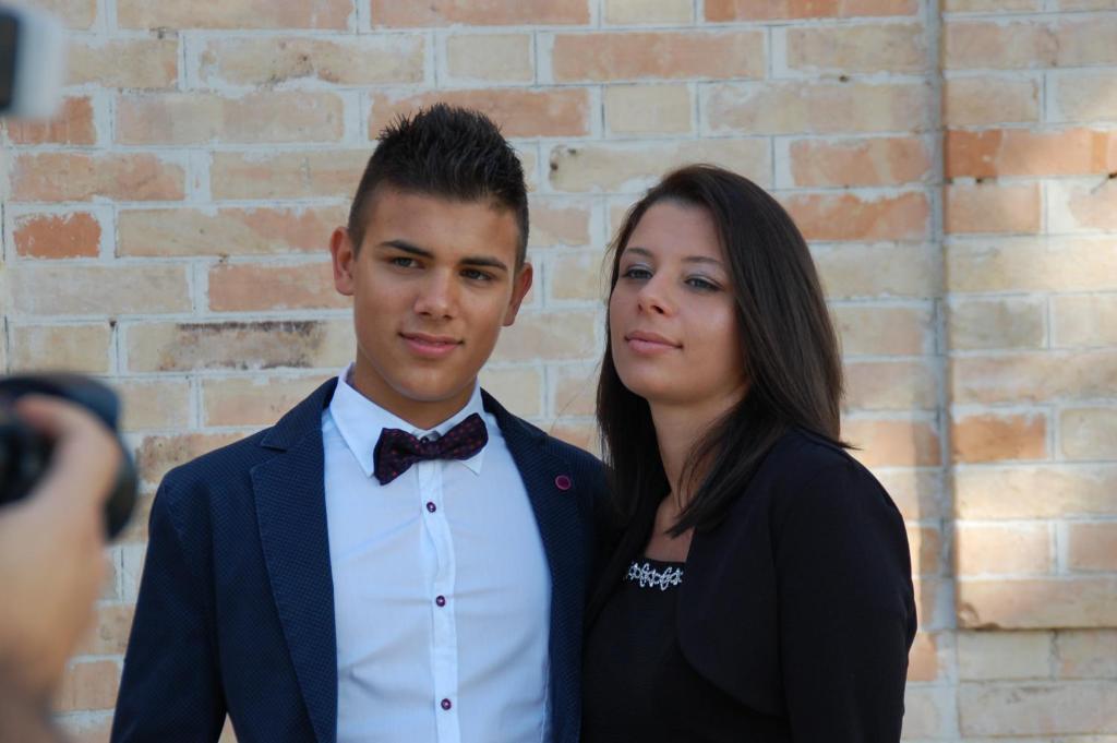 a man and a woman in front of a brick wall at L'Oasi di Pierino in Grottazzolina