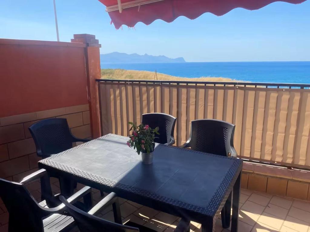 a blue table and chairs on a balcony with the ocean at Casa Vacanze Fabrizio in Balestrate
