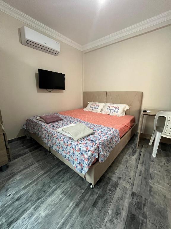 a bedroom with a bed and a flat screen tv at Flat in Manavgat in Manavgat
