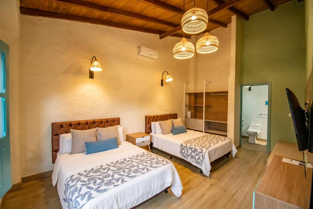 Postel nebo postele na pokoji v ubytování Hotel Salento Real Eje Cafetero