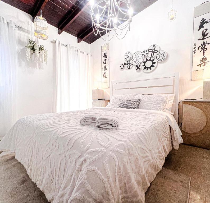 a bedroom with a bed with a white comforter at ORHO HOTEL BOUTIQUE PANAMA Tocumen Airport free shuttle highway round trip 15 minuts in Tocumen