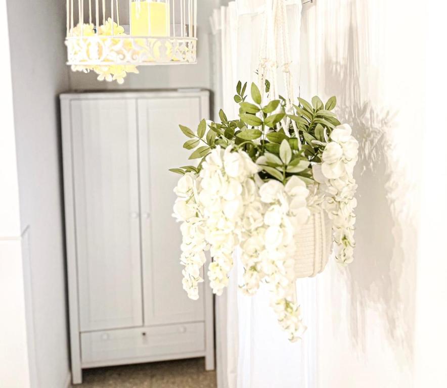 a hanging arrangement of white flowers in a room at ORHO HOTEL BOUTIQUE PANAMA Tocumen Airport free shuttle highway round trip 15 minuts in Tocumen