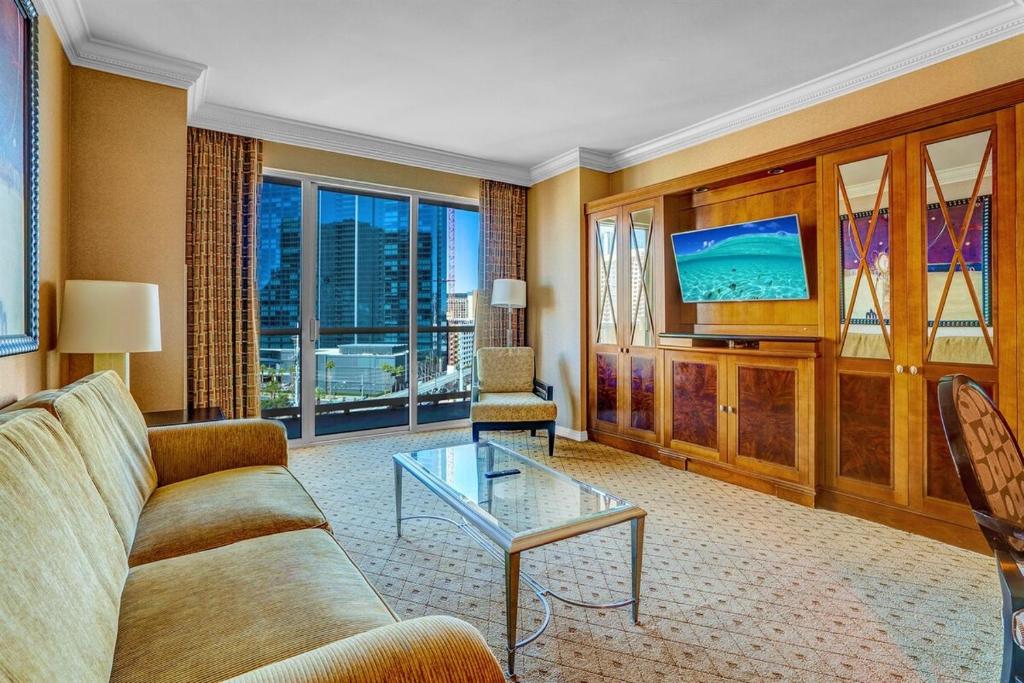 a living room with a couch and a tv at MGM 1BR Suite 7th Floor Strip View, Balcony in Las Vegas