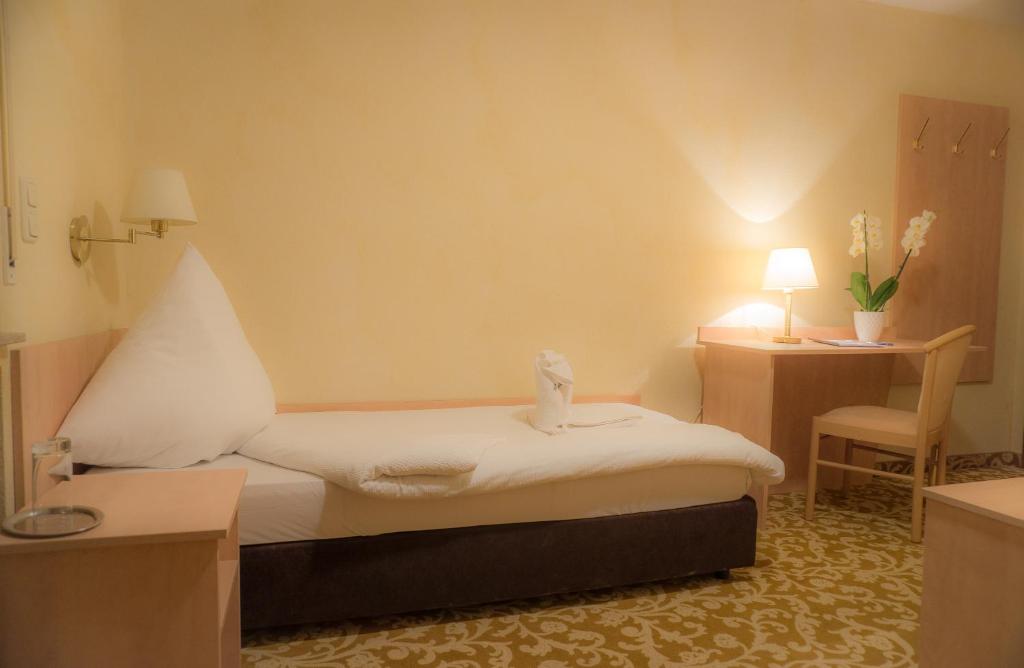 Postel nebo postele na pokoji v ubytování Hotel-Restaurant Alpha