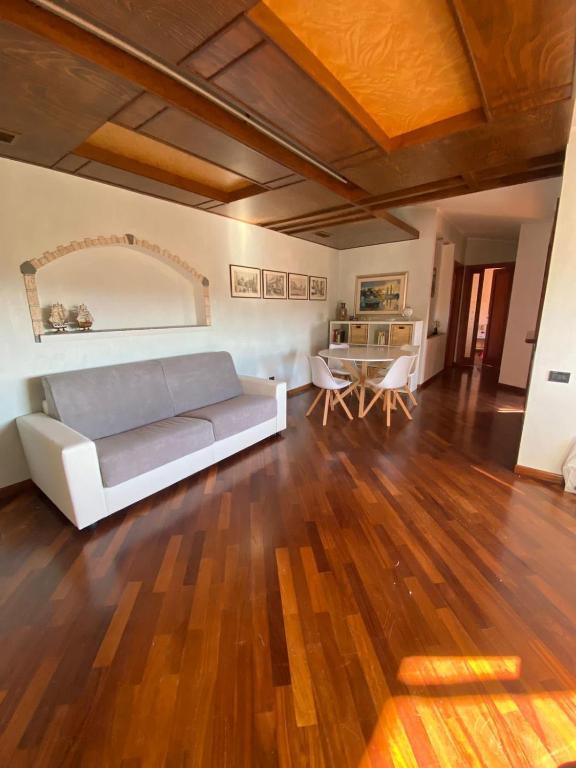 a living room with a couch and a table at Zanella House in Quartu SantʼElena