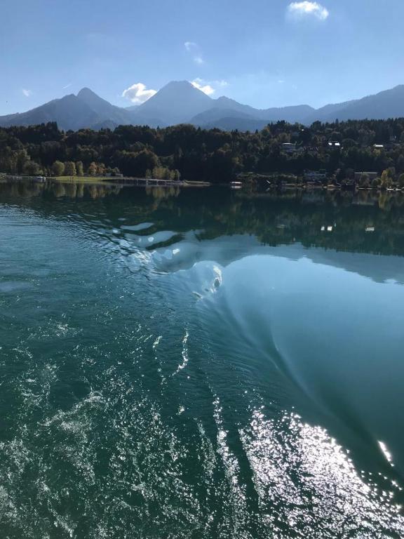 a large body of water with mountains in the background at Fewos Wuzella Faaker See in Latschach