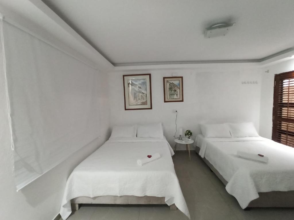 Postel nebo postele na pokoji v ubytování Hostal Casa de las Americas