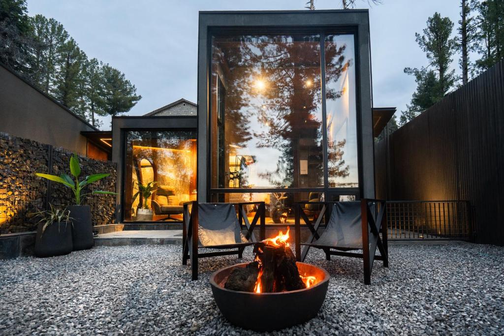 un patio con 2 sillas y una hoguera en ESCAPE Hotels & Resorts, en Nathia Gali