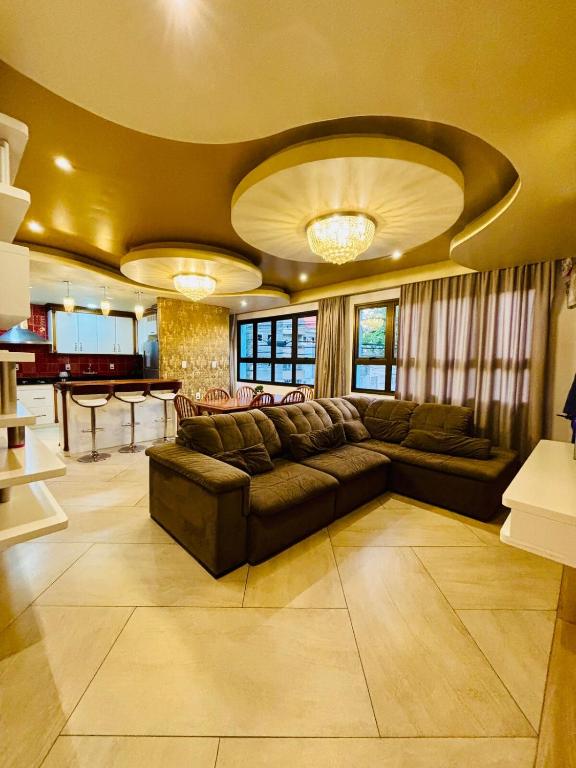 a large living room with a couch and a table at Apartamento Duplex Rio grande centro 250 m privado dois quartos in Rio Grande